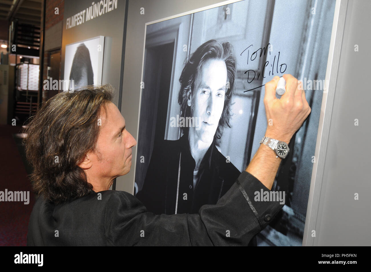 Actor Tom DiCillo signs his portrait at Filmfest München 2011 Stock Photo