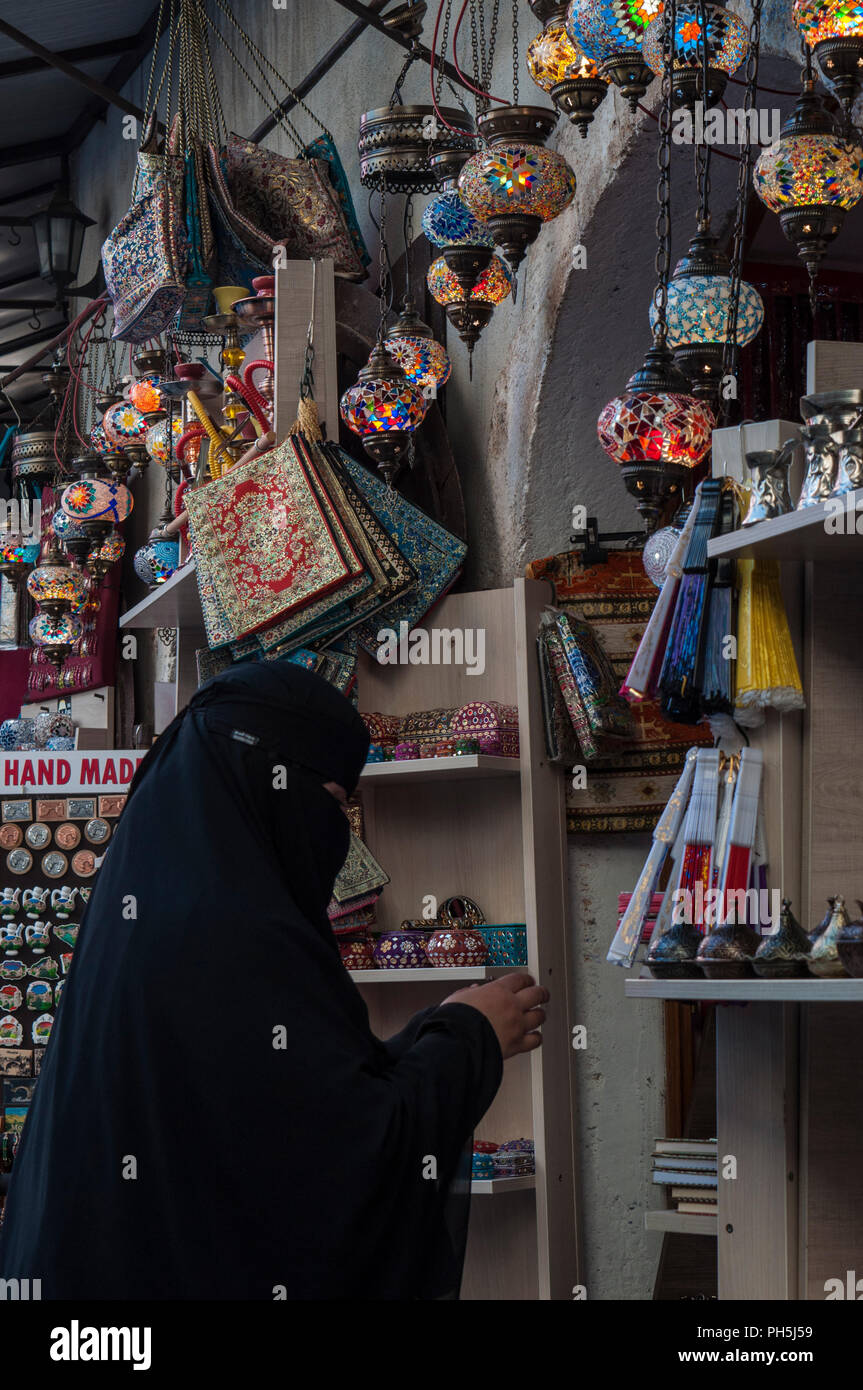 Bosnia: a veiled muslim woman goes shopping in one of the many shops of the Old Bazaar Kujundziluk, the muslim quarter of the old town of Mostar Stock Photo