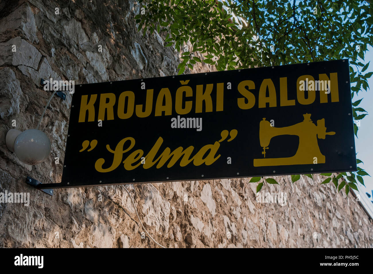 Bosnia: the sign of an old tailor shop in the alley of the old town of Mostar with its antique craft shops Stock Photo