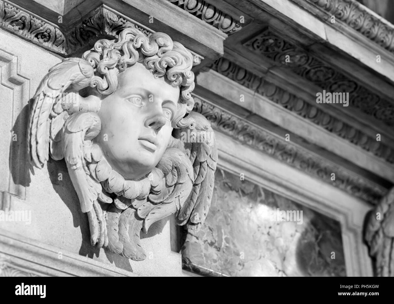 angel face inside the Milan cathedral, black and white photography