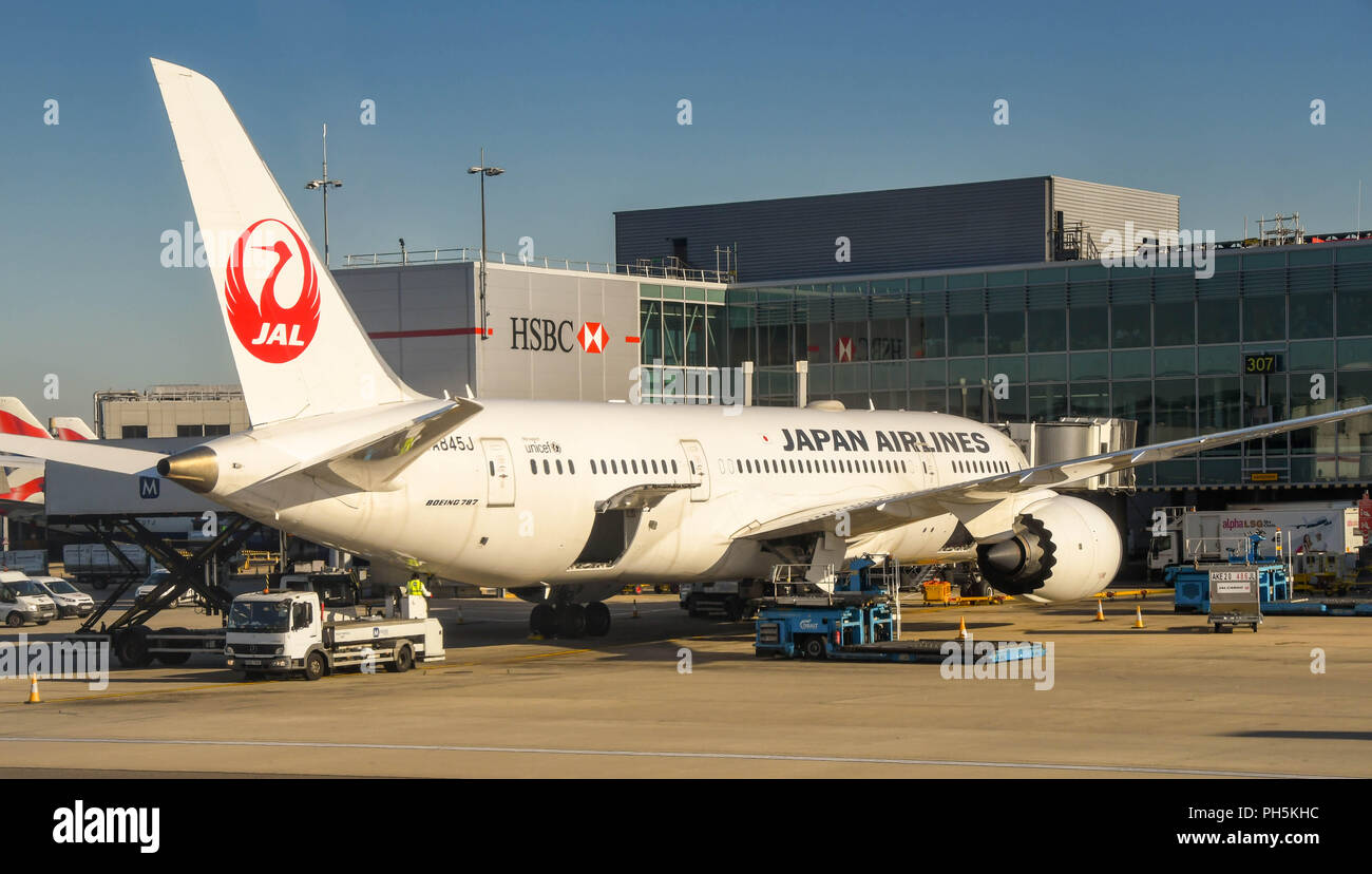 Japan Airlines Boeing 787 Dreamliner with ground handling equipment around it at London Heathrow airport. Stock Photo
