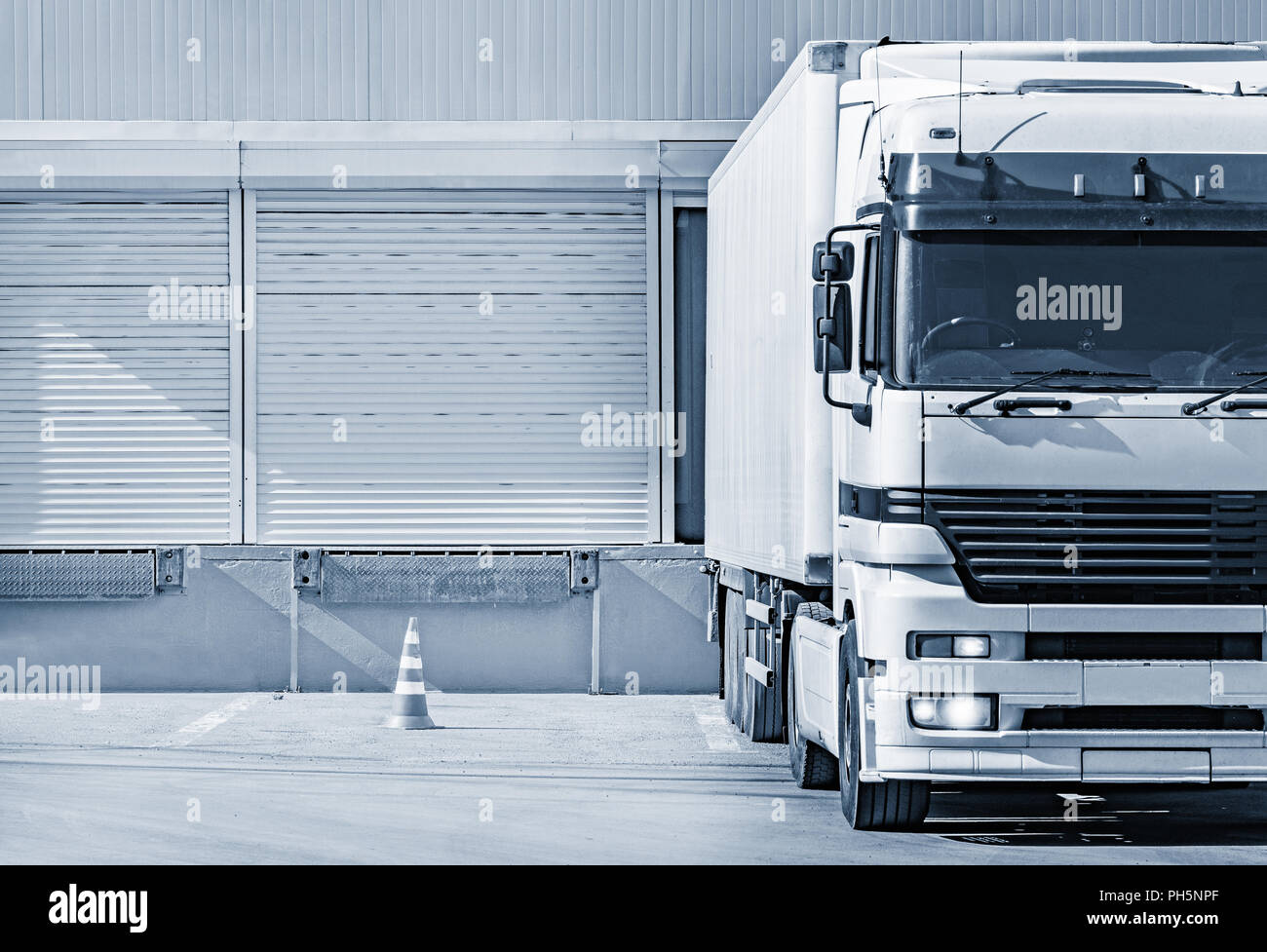Freight truck stands by the door of the storage. Stock Photo