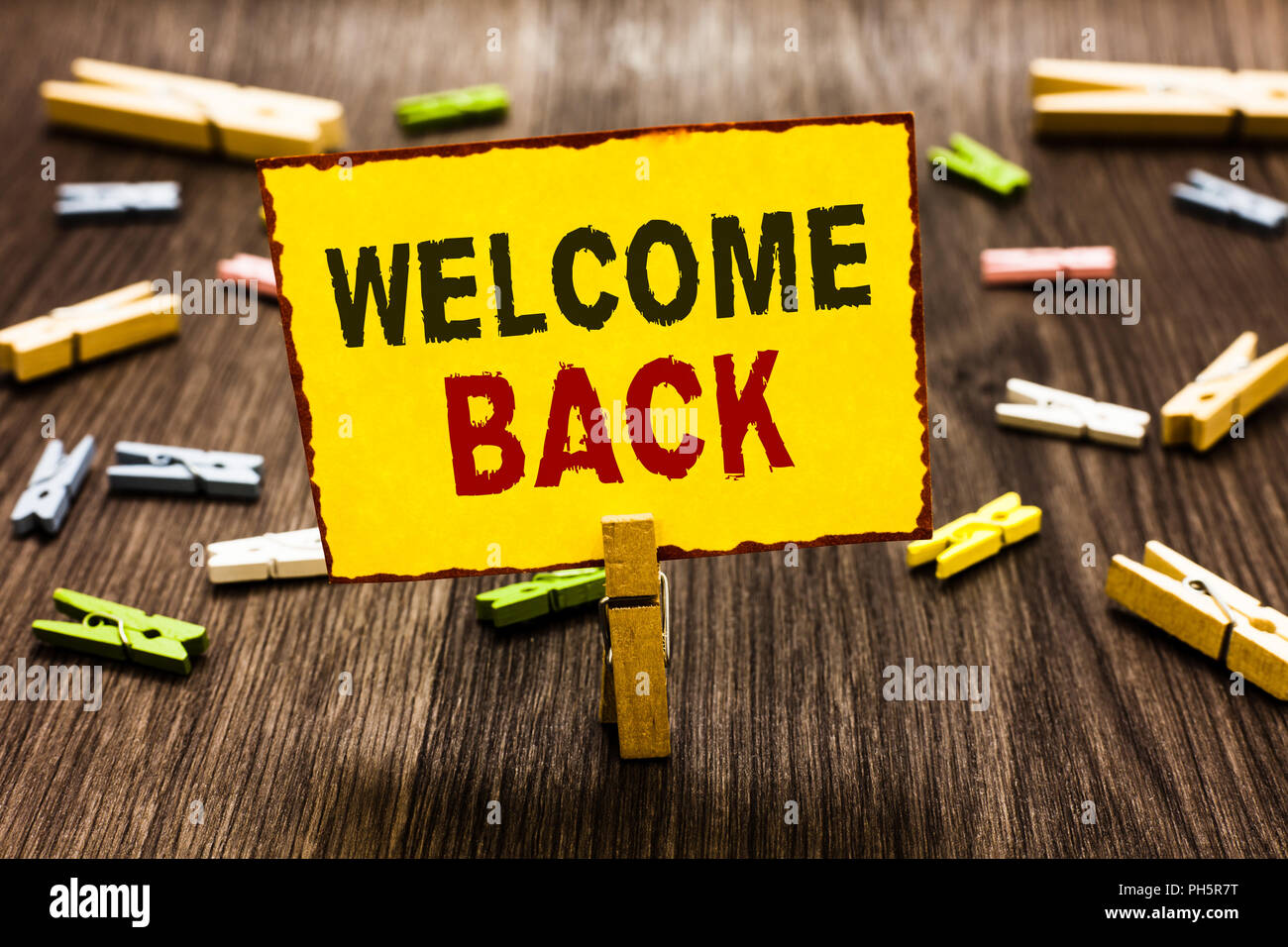Handwriting text writing Welcome Back. Concept meaning Warm Greetings  Arrived Repeat Gladly Accepted Pleased Clothespin holding yellow paper note  seve Stock Photo - Alamy