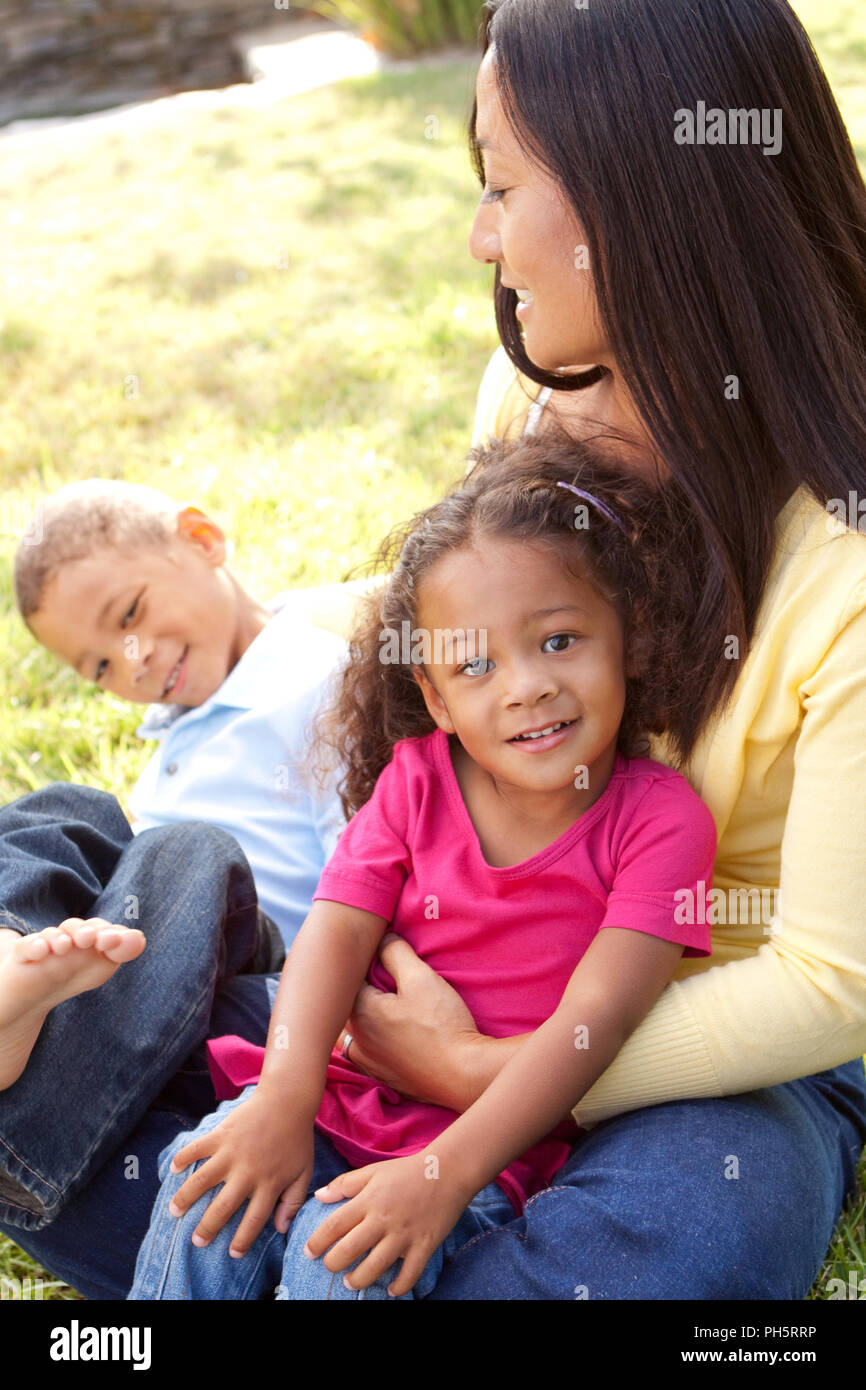 Mixed race mother and her children. Stock Photo