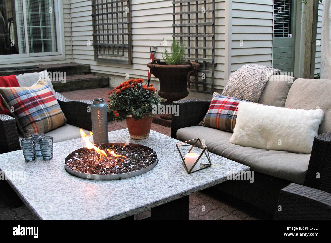Outdoor Seating Arrangement Around A Gas Fire Pit Table In The