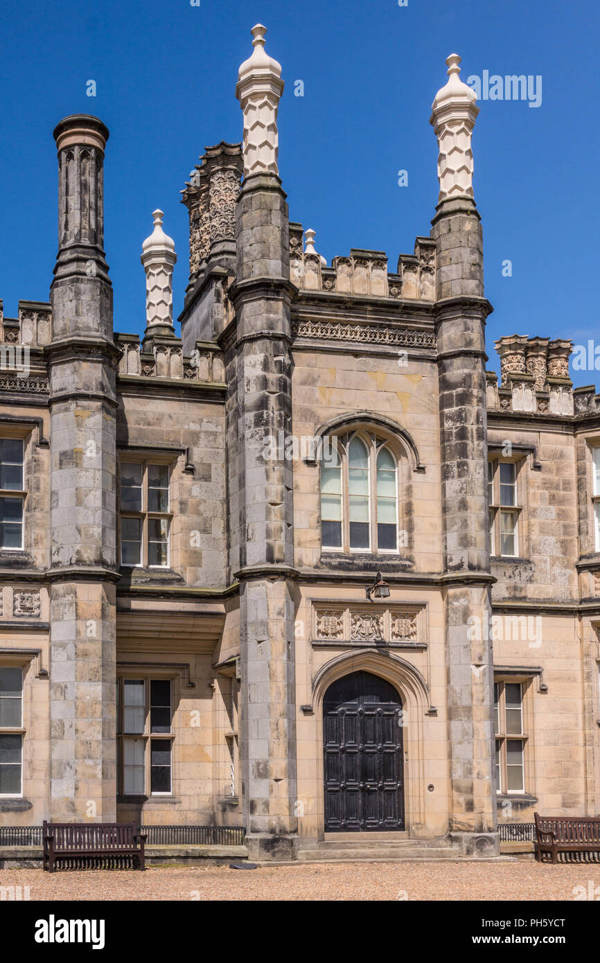 Edinburgh, Scotland, UK - June 14, 2012: Main entrance and tower of Dalmany house, mansion and castle in Tudor revival style. Blue sky. Stock Photo