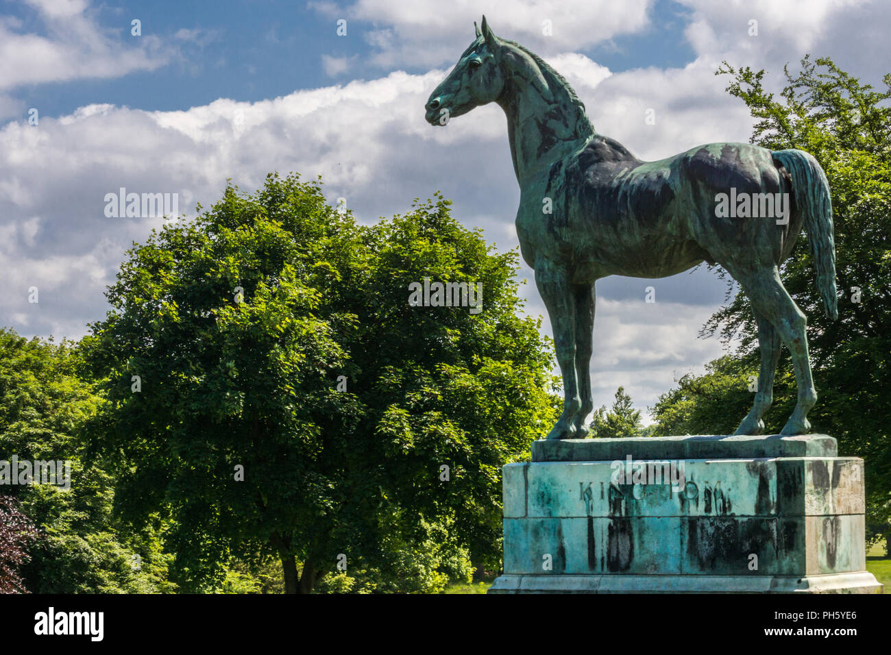 Edinburgh, Scotland, UK - June 14, 2012:Closeup of Horse statue of King Tom looking at Firth of Forth at Dalmeny House. Green trees in back, cloudscap Stock Photo