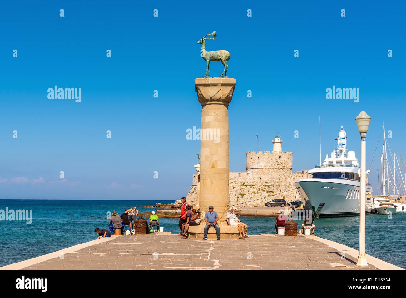 RHODES, GREECE May 13, 2018 Bronze deer statue in Mandraki harbor of
