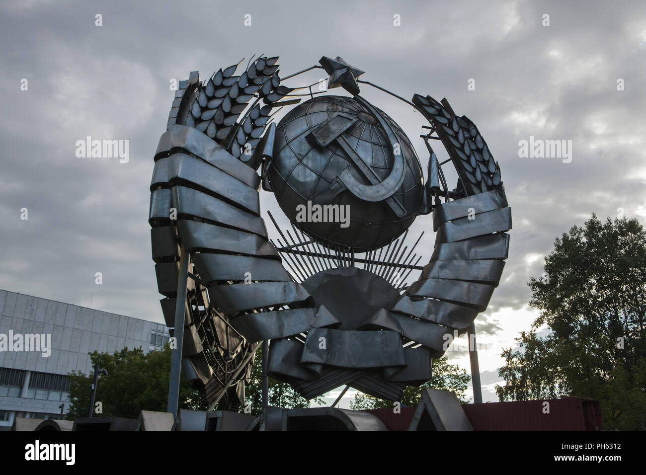 State Emblem of the Soviet Union designed by Soviet sculptor Stepan Schekotikhin on display in the Muzeon Fallen Monument Park in Moscow, Russia. The huge stainless state emblem was previously instated in Leninsky Avenue in Moscow. Stock Photo
