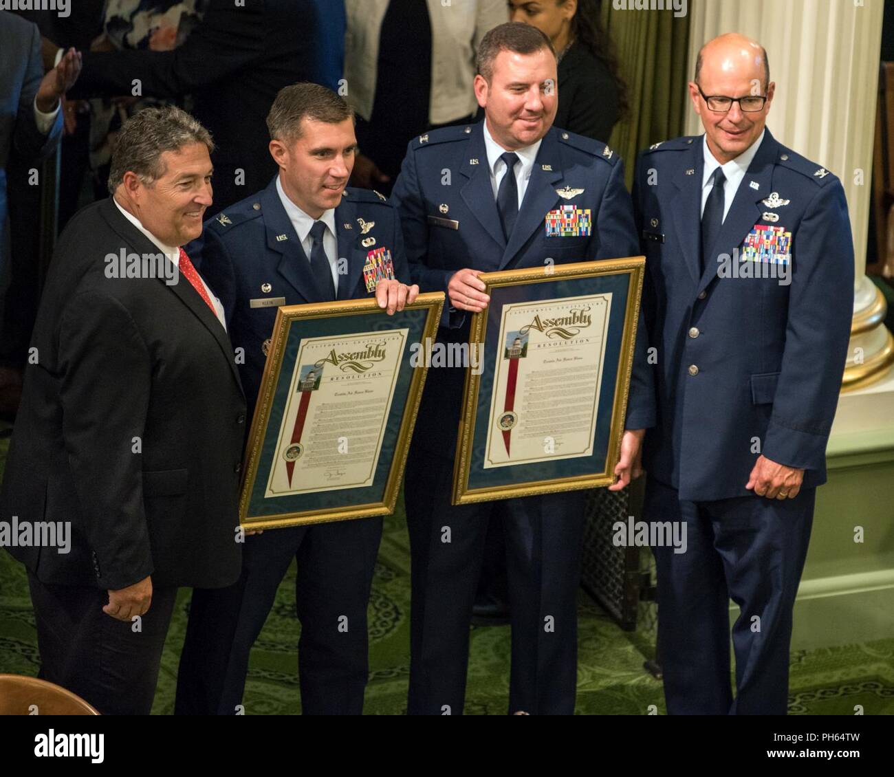 Assemblymember Jim Frazier presents Col. John Klein, 60th Air Mobility Wing commander, with a California State Assembly Resolution honoring the 75th Anniversary of Travis Air Force Base at the California State Capitol, Sacramento, June 25, 2018.  For the past 75 years, Travis AFB has been a focal point for the world as a power projection platform, a means to deliver hope, and a mission fueled by community support. Stock Photo