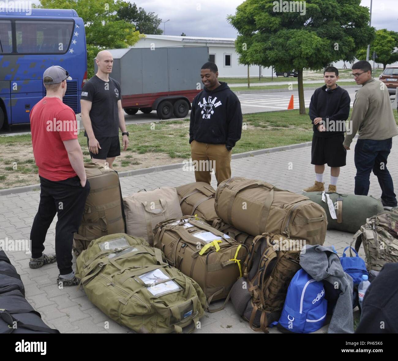 Capt. Jaytoine Milledge, 2-5 CAV, 1st Armored Brigade Combat Team, 1st Cavalry Division’s fire support officer, center, greets Airmen from the 9th Air Support Operations Squadron and Soldiers from B Co, 2-5 CAV, 1st BDE, 1CD at Mihail Kogalniceanu Air Base, Romania, June 23, 2018.  The Airmen and the Soldiers are relocating to Romania to continue supporting the Atlantic Resolve exercise. Stock Photo