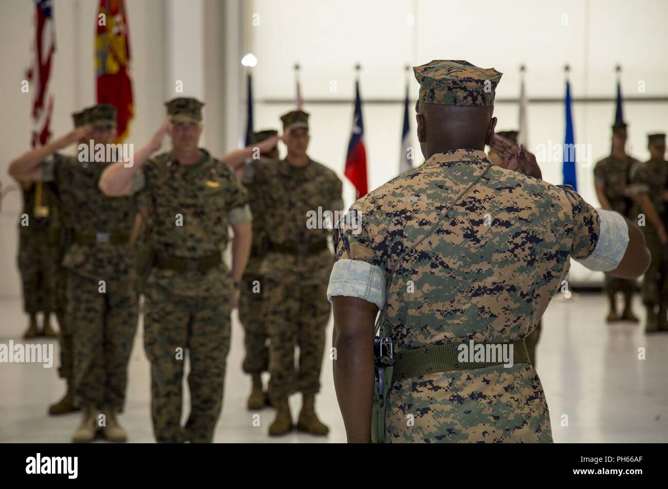 Lt. Col. Quentin Vaughn, right, commanding officer, Headquarters and Headquarters Squadron (H&HS), Marine Corps Air Station New River, renders honors during a change of command ceremony for H&HS at the Center for Naval Aviation Technical Training on MCAS New River, N.C., June 15, 2018. The change of command formally transferred authorities and responsibilities of H&HS from Vaughn to Lt. Col. Matthew T. Daigneault. Stock Photo