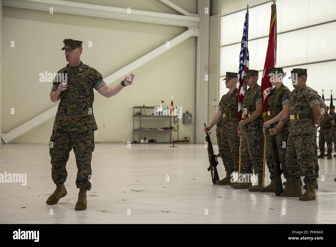 Col. Russell C. Burton, left, commanding officer, Marine Corps Air Station New River, gives his remarks during a change of command ceremony for Headquarters and Headquarters Squadron (H&HS), MCAS New River, at the Center for Naval Aviation Technical Training on New River, N.C., June 15, 2018. The change of command formally transferred authorities and responsibilities of H&HS from Lt. Col. Quentin Vaughn to Lt. Col. Matthew T. Daigneault. Stock Photo