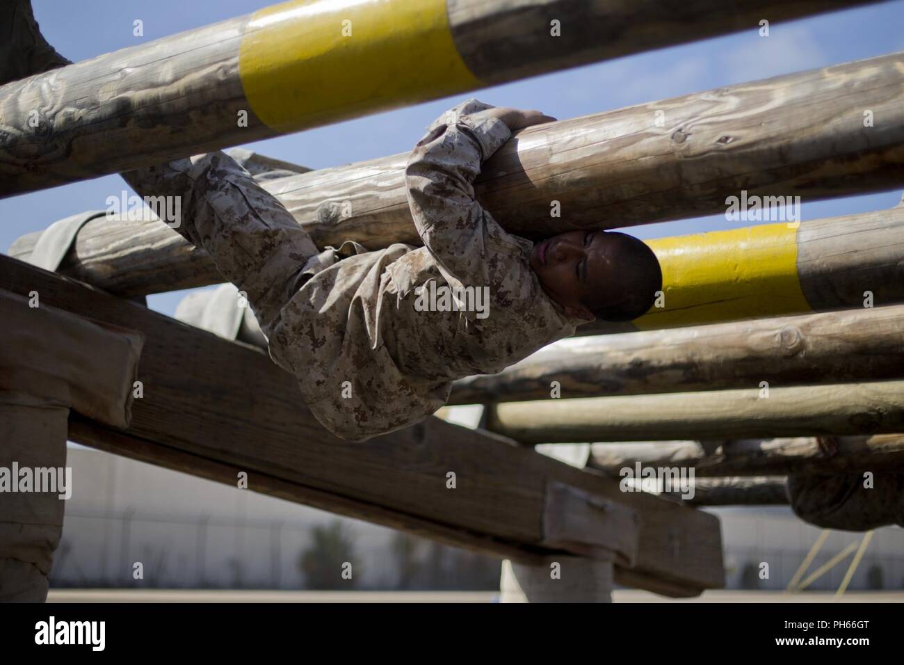 A recruit with Bravo Company, 1st Recruit Training Battalion, scale an obstacle during a confidence course event at Marine Corps Recruit Depot San Diego, June 25. During the confidence course, recruits were required to achieve each obstacle within a limited time. Many of the obstacles test the recruits’ confidence and mental strength in overcoming the challenges before them. Annually, more than 17,000 males recruited from the Western Recruiting Region are trained at MCRD San Diego. Bravo Company is scheduled to graduate Aug. 31. Stock Photo