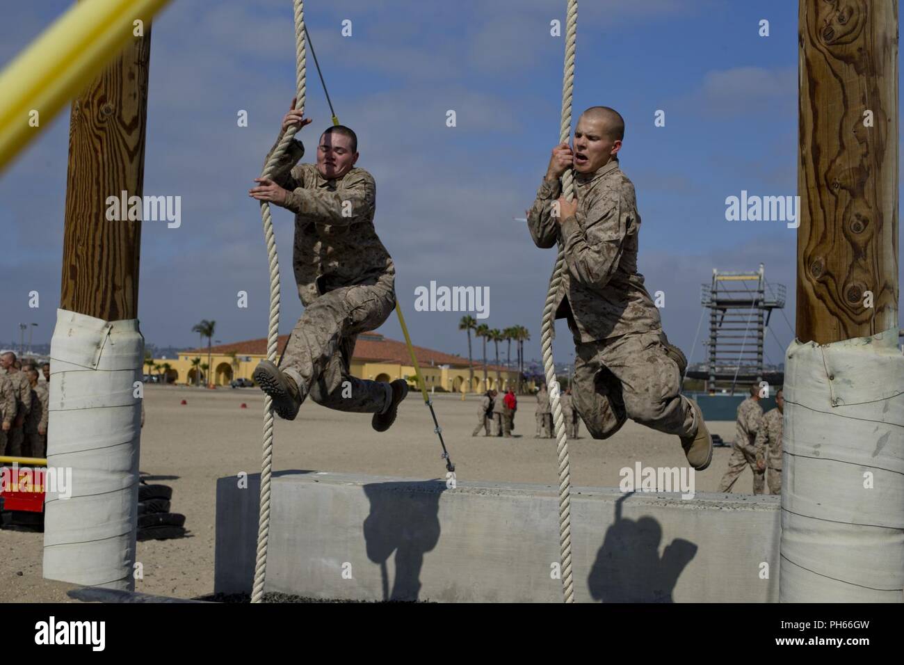 Recruits with Bravo Company, 1st Recruit Training Battalion, swing on a rope during a confidence course event at Marine Corps Recruit Depot San Diego, June 25. Throughout the confidence course recruits were situated to overcome each obstacle to overcome fear and increase confidence amongst themselves. Annually, more than 17,000 males recruited from the Western Recruiting Region are trained at MCRD San Diego. Bravo Company is scheduled to graduate Aug. 31. Stock Photo