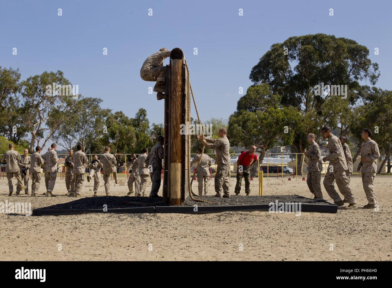 Recruits with Bravo Company, 1st Recruit Training Battalion, scales a wall during a confidence course event at Marine Corps Recruit Depot San Diego, June 25. Upon scaling the wall, recruits practiced multiple Marine Corps Martial Arts Program techniques. Other obstacles in the course included the Monkey Bridge, Skyscraper Wall Climb and several others. Annually, more than 17,000 males recruited from the Western Recruiting Region are trained at MCRD San Diego. Bravo Company is scheduled to graduate Aug. 31. Stock Photo