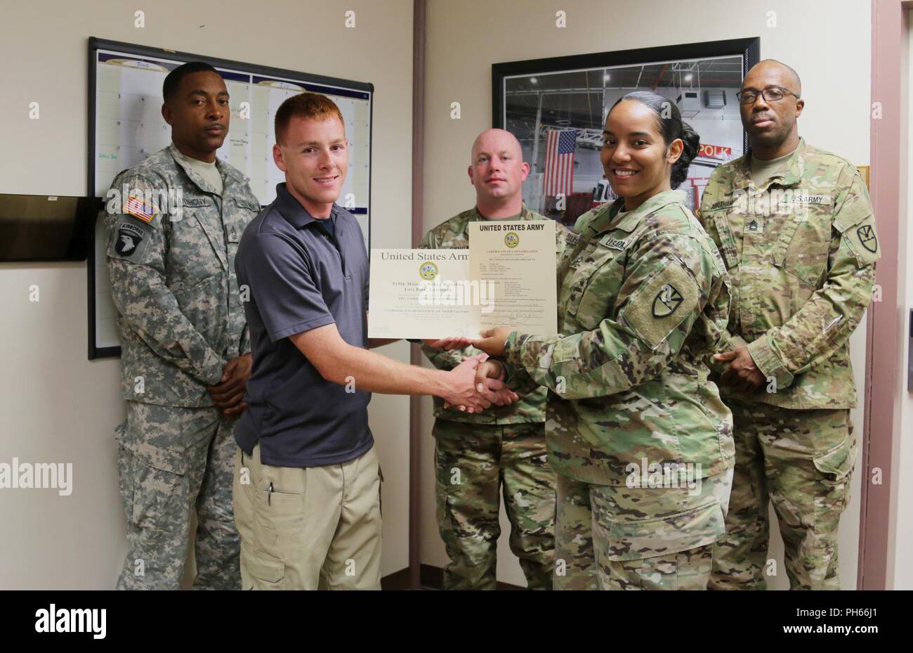 Pvt. 1st Class Yamaliz Solano-Rosario, Virgin Islands National Guard 661st  Military Police Law and Order Detachment, receives her certificate from  Staff Sgt. Patrick Sanders, Ft. Polk 91st Military Police Detachment, for  completing