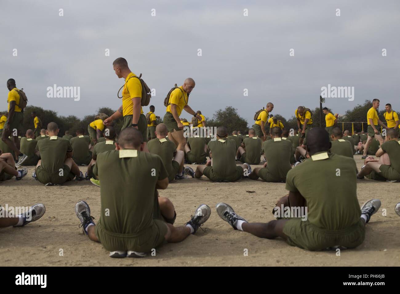Drill instructors with Fox Company, 2nd Recruit Training Battalion, supervise recruits as they perform crunches during a physical fitness test at Marine Corps Recruit Depot San Diego, June 25. During this portion of the test, recruits must perform as many crunches as possible within two minutes. Annually, more than 17,000 males recruited from the Western Recruiting Region are trained at MCRD San Diego. Fox Company is scheduled to graduate Aug. 10. Stock Photo