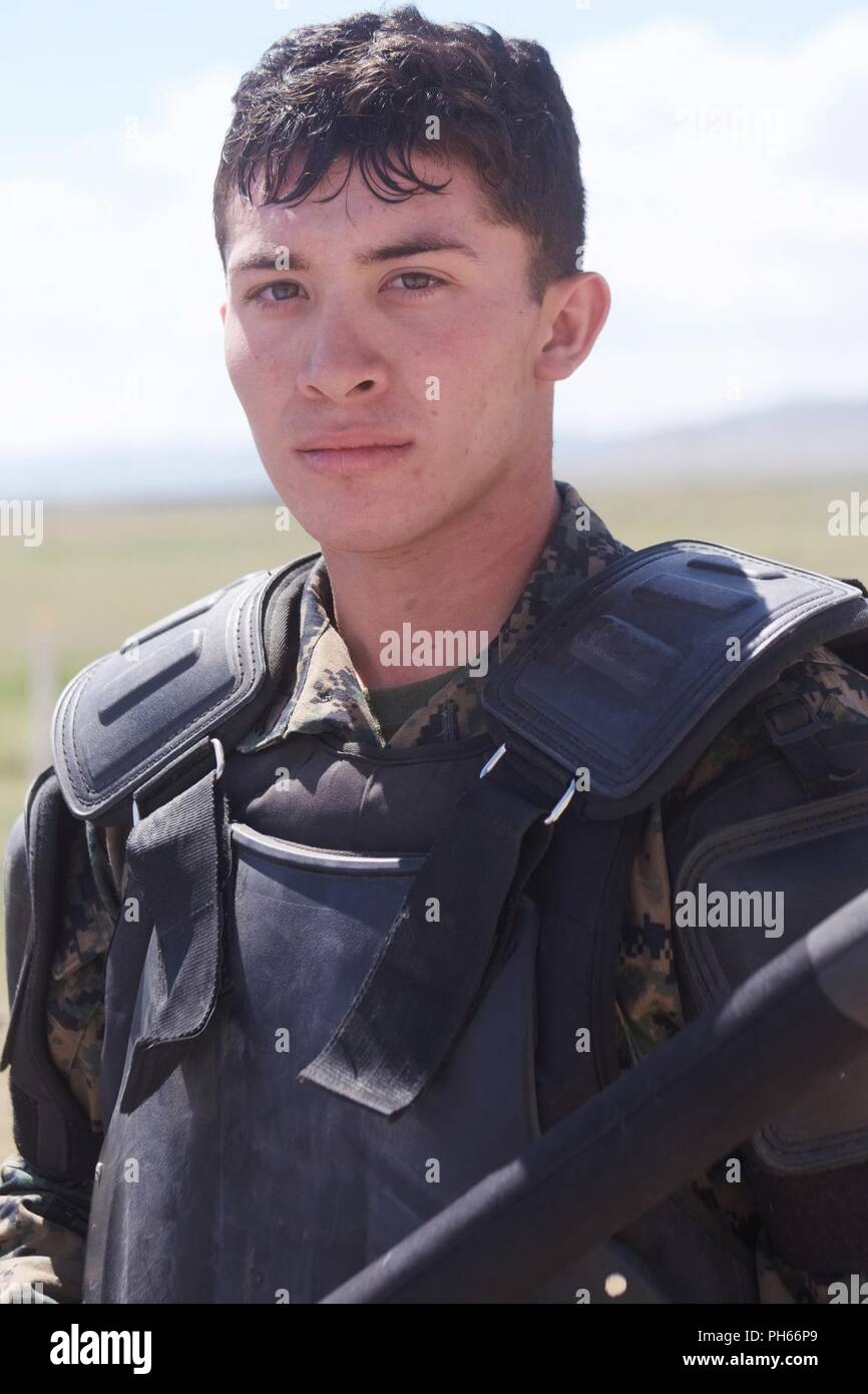 U.S. Marine Corps Lance Cpl. Andres Delgado is a military police Marine assigned to 3rd Law Enforcement Battalion participating in Khaan Quest 2018 at Five Hills Training Area, Mongolia. Delgado, a native of Amarillo, Texas, wears riot gear during a crowd-control exercise. Khaan Quest 2018 is a regularly scheduled, multinational exercise co-sponsored by U.S. Pacific Command and hosted annually by the Mongolian Armed Forces. KQ18 is the latest in a continuing series of exercises designed to promote regional peace and security. This year’s exercise marks the 16th anniversary of this training eve Stock Photo
