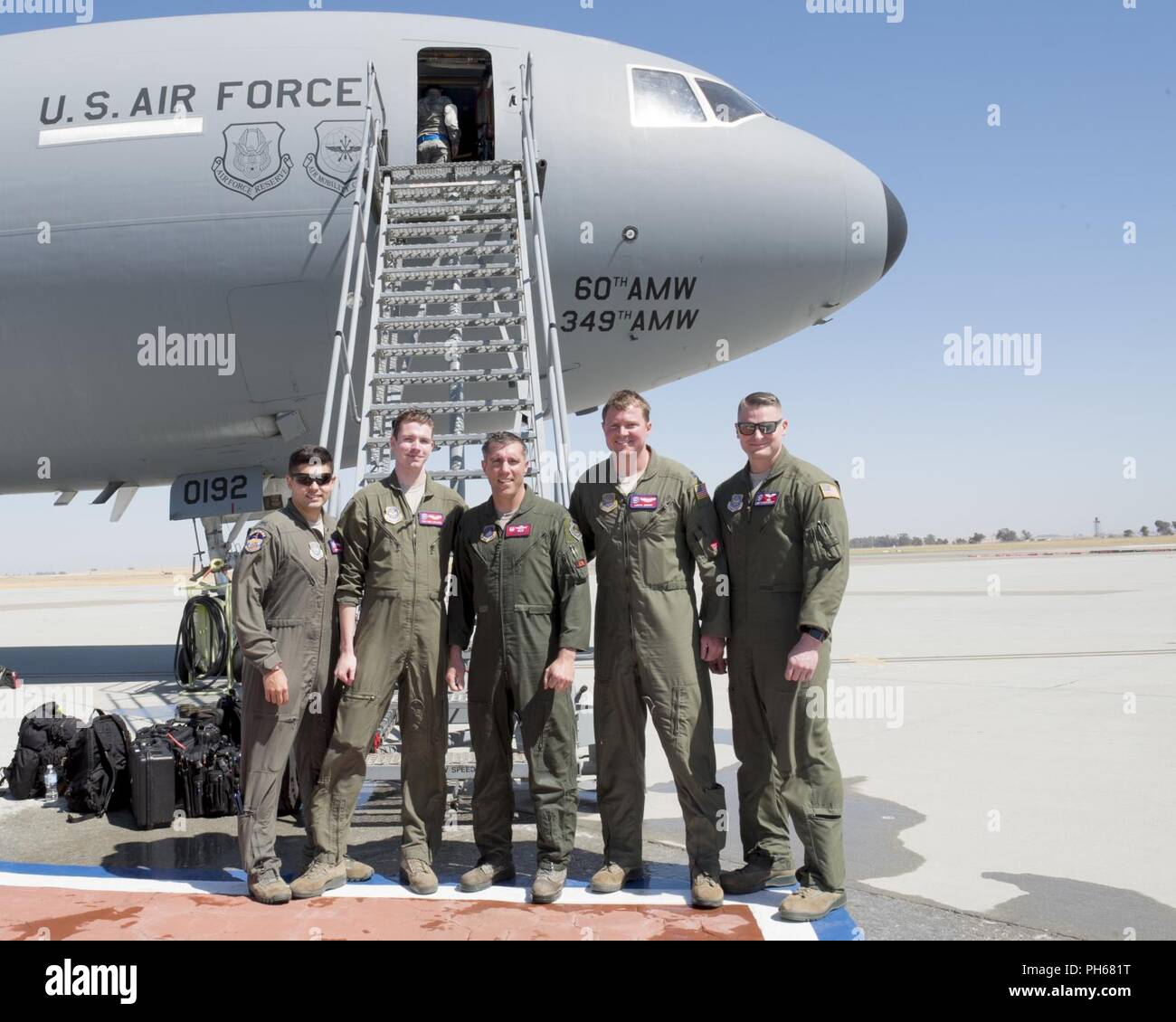 Col. John Klein, 60th Air Mobility Wing commander, center, poses for a photo with a 9th Air Refueling Squadron air crew after completing his “fini-flight” at Travis Air Force Base, Calif., June 27, 2018. Klein has been the wing commander since June 2016, and will begin his new assignment with the Council of Foreign Relations in New York. Stock Photo