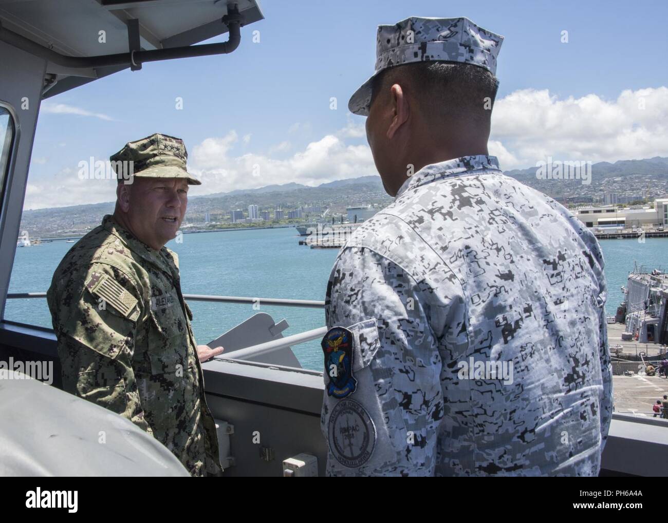PEARL HARBOR (June 29, 2018) Vice Adm. John D. Alexander, commander, U.S. 3rd Fleet, speaks with the Philippine Navy landing platform dock BRP Davao Del Sur (LD 602) Commanding Officer, Capt. Richard M. David, while on the bridge of the ship, June 29.  Twenty-five nations, more than 45 ships and submarines, about 200 aircraft and 25,000 personnel are participating in RIMPAC from June 27 to Aug. 2 in and around the Hawaiian Islands and Southern California. The world’s largest international maritime exercise, RIMPAC provides a unique training opportunity while fostering and sustaining cooperativ Stock Photo