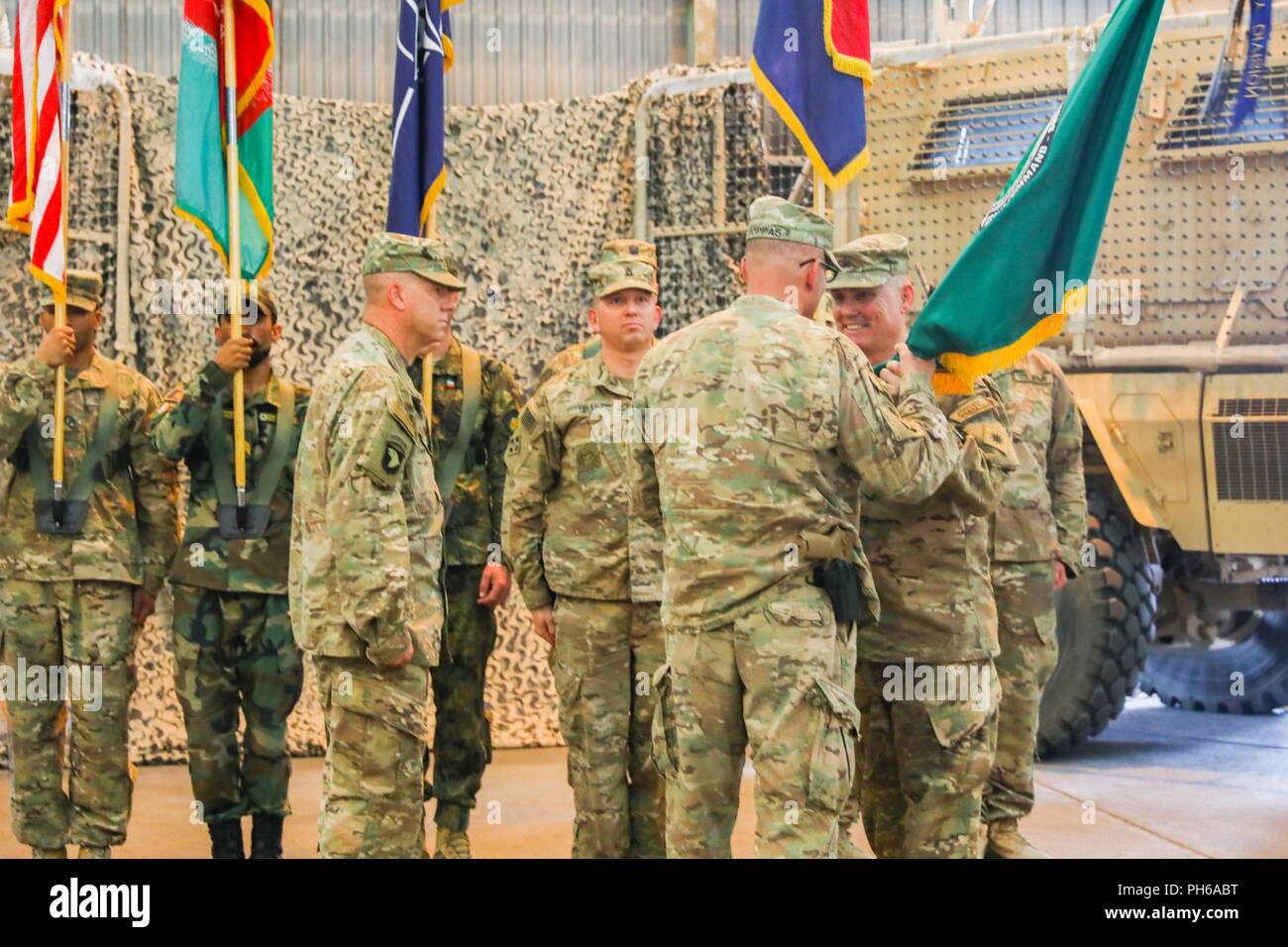 KANDAHAR AIRFIELD, Afghanistan (June 30, 2018) -- U.S. Army Maj. Gen. Andrew Poppas, deputy chief of staff for operations for Resolute Support and the deputy commanding general for operations for U.S. Forces Afghanistan, takes the Train, Advise and Assist Command-South colors from U.S. Army Brig. Gen. John Lathrop, outgoing commander for TAAC-South, June 30, 2018 during a Transfer of Authority ceremony in  Kandahar, Afghanistan. Lathrop, assigned to the 40th Infantry Division, California National Guard, outgoing commander, relinquished authority of TAAC-South to U.S. Army Brig. Gen. Jeffrey Sm Stock Photo