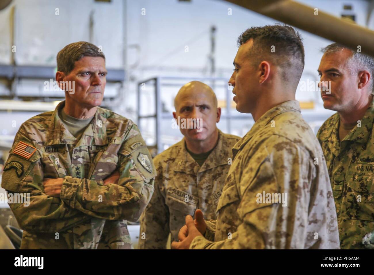 ARABIAN GULF (June 22, 2018) U.S. Army Gen. Joseph Votel, commander, U.S. Central Command,  speaks with U.S. Marine Corps Sgt. Mason McLaughlin aboard the Wasp-class amphibious assault ship USS Iwo Jima (LHD 7), June 22, 2018. Votel, Vice Adm. Scott Stearney, commander, U.S. Naval Forces Central Command, and other distinguished visitors took a tour of Iwo Jima and spoke with crew members and Marines with the 26th Marine Expeditionary Unit, who are currently deployed to the U.S. 5th Fleet of operations in support of maritime security operations to reassure allies and partners and preserve the f Stock Photo