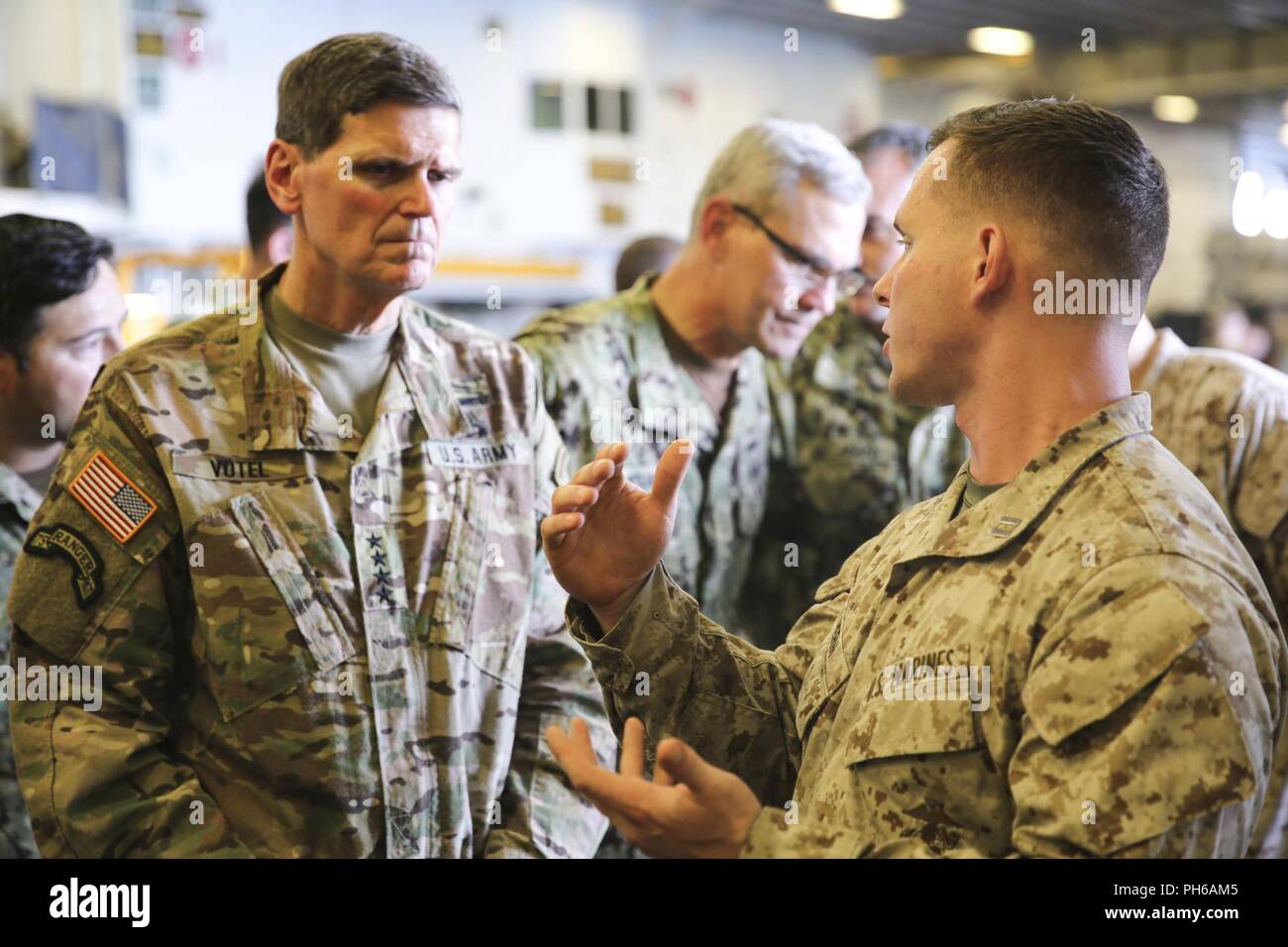 ARABIAN GULF (June 22, 2018) U.S. Army Gen. Joseph Votel, commander, U.S. Central Command,  speaks with U.S. Marine Corps Capt. Daniel Herm aboard the Wasp-class amphibious assault ship USS Iwo Jima (LHD 7), June 22, 2018. Votel, Vice Adm. Scott Stearney, commander, U.S. Naval Forces Central Command, and other distinguished visitors took a tour of Iwo Jima and spoke with crew members and Marines with the 26th Marine Expeditionary Unit, who are currently deployed to the U.S. 5th Fleet of operations in support of maritime security operations to reassure allies and partners and preserve the freed Stock Photo