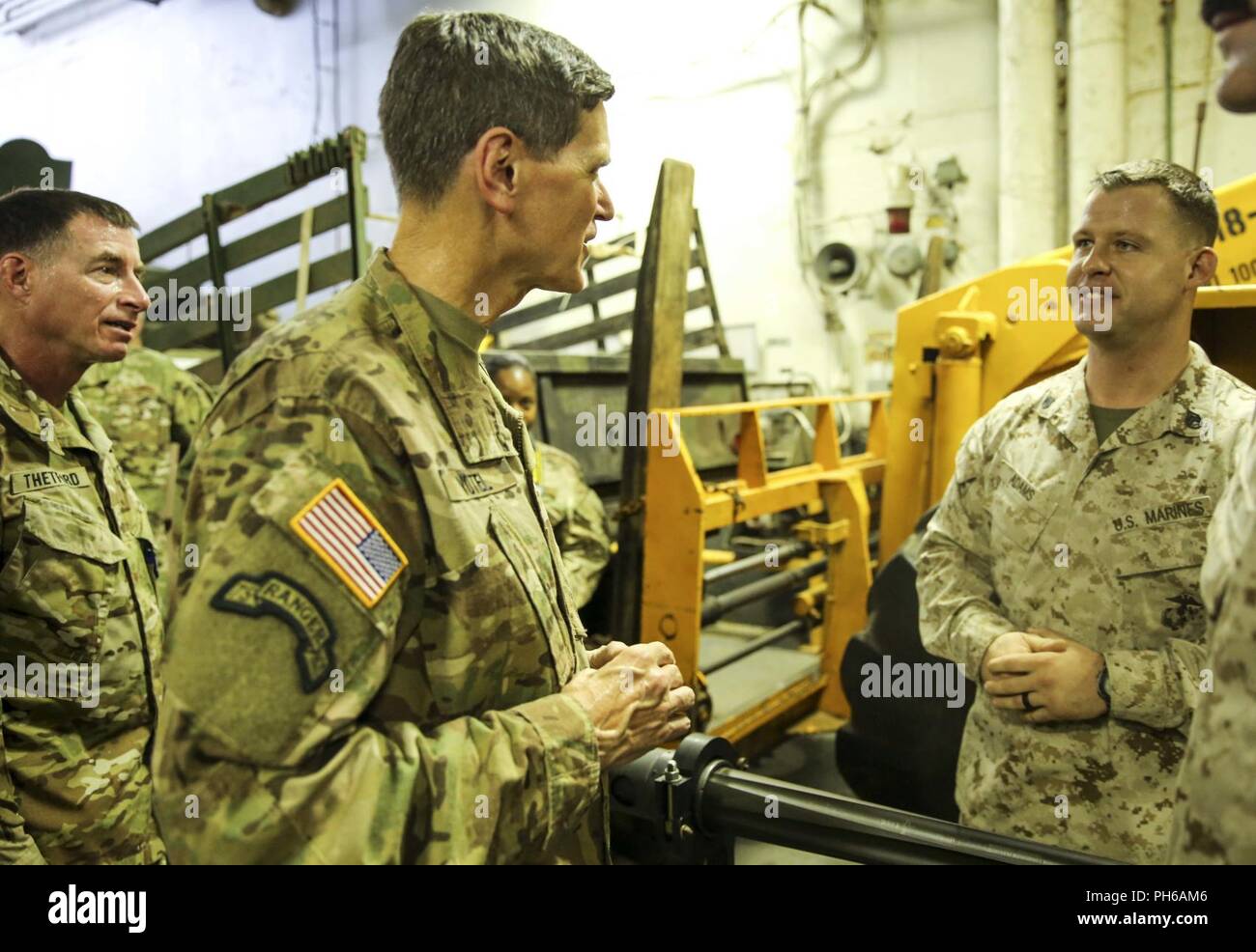 ARABIAN GULF (June 22, 2018) U.S. Army Gen. Joseph Votel, commander, U.S. Central Command,  speaks with U.S. Marine Corps Staff Sgt. Tristan Adams aboard the Wasp-class amphibious assault ship USS Iwo Jima (LHD 7), June 22, 2018. Votel, Vice Adm. Scott Stearney, commander, U.S. Naval Forces Central Command, and other distinguished visitors took a tour of Iwo Jima and spoke with crew members and Marines with the 26th Marine Expeditionary Unit, who are currently deployed to the U.S. 5th Fleet of operations in support of maritime security operations to reassure allies and partners and preserve th Stock Photo