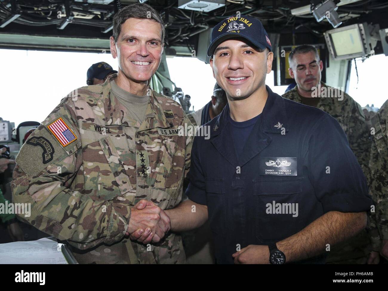 ARABIAN GULF (June 22, 2018) U.S. Army Gen. Joseph Votel, commander, U.S. Central Command, poses for a picture with U.S. Navy Boatswain’s Mate 3rd Class Danny Vazquez  aboard the Wasp-class amphibious assault ship USS Iwo Jima (LHD 7), June 22, 2018. Votel, Vice Adm. Scott Stearney, commander, U.S. Naval Forces Central Command, and other distinguished visitors took a tour of Iwo Jima and spoke with crew members and Marines with the 26th Marine Expeditionary Unit, who are currently deployed to the U.S. 5th Fleet of operations in support of maritime security operations to reassure allies and par Stock Photo