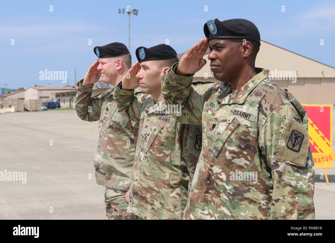 Col. Richard Wright, 35th Air Defense Artillery Brigade commander, Lt. Col. Marc Pelini, outgoing commander of 6th Battalion, 52nd Air Defense Artillery Regiment, and Lt. Col. Matthew Walker, 6-52 ADA Bn. Incoming commander, salute as The National Anthem is played during a change of command ceremony, June 15, 2018, at Suwon Air Base, Republic of Korea. Pelini relinquished command to Walker, following a two-year command marked by high achievements in readiness. ( Stock Photo