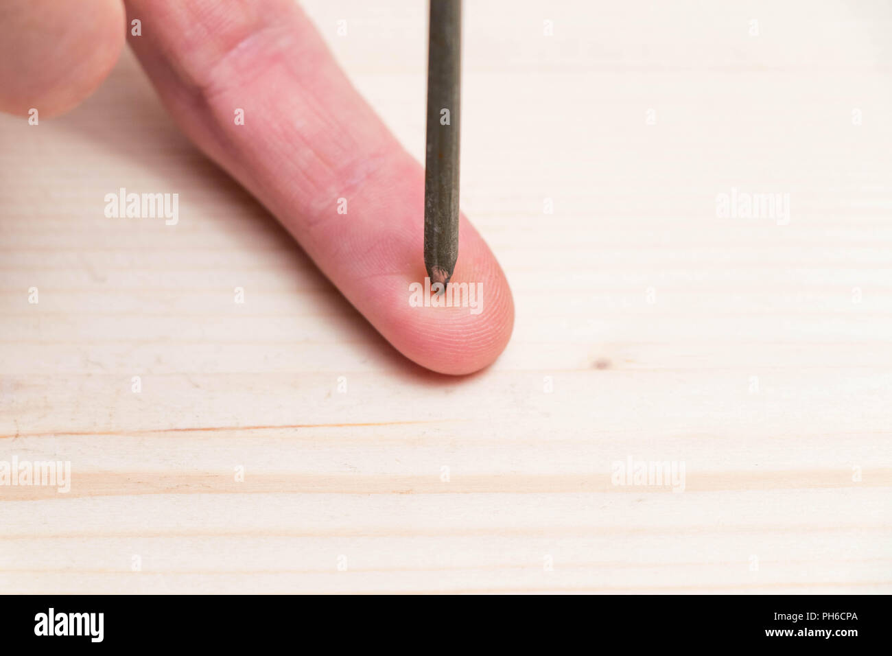 Hand finger nail spike danger hold hurt injury Stock Photo Alamy