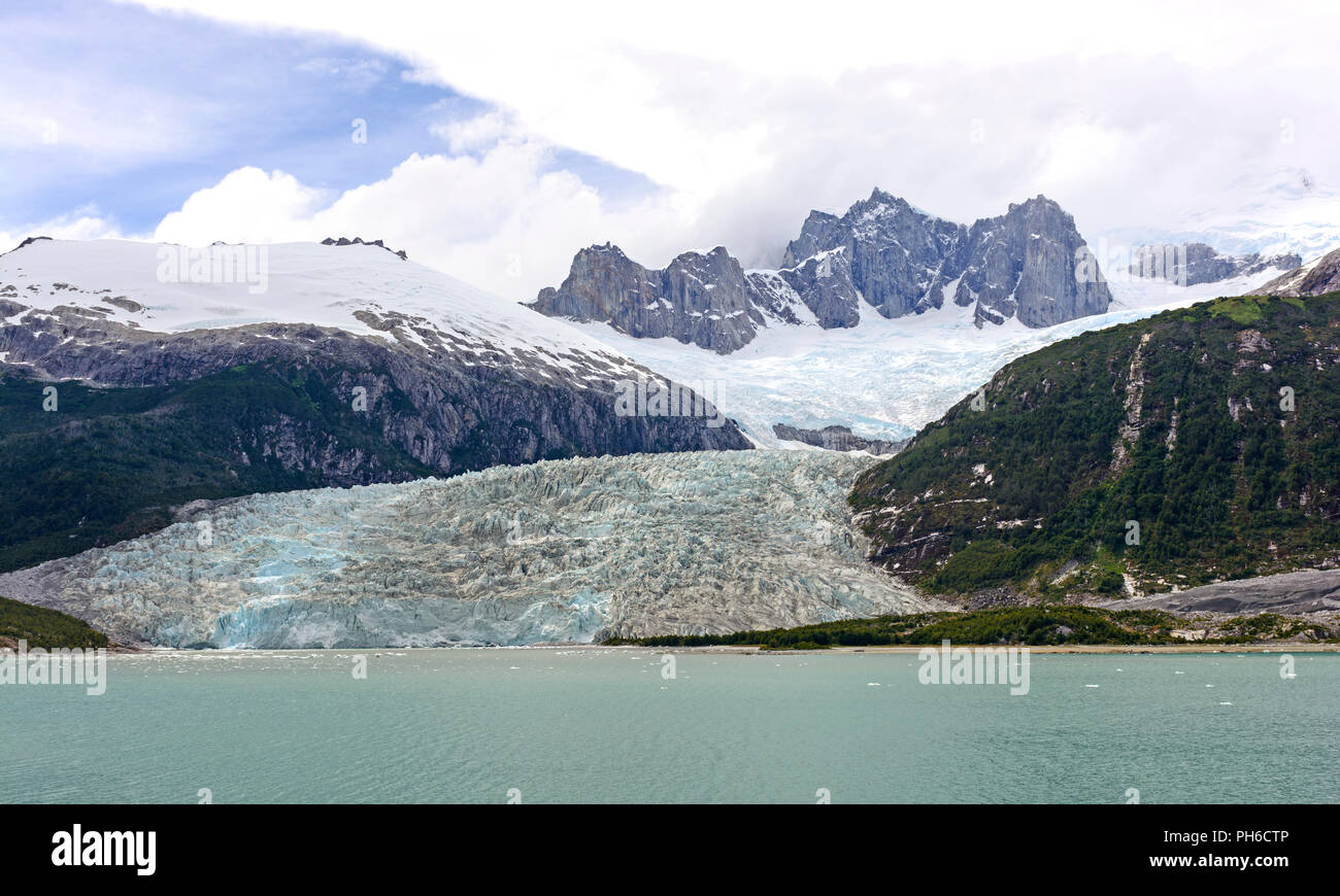 The Pia Tidewater Glacier and Dramatic Peaks in Tierra del Fuego Stock Photo