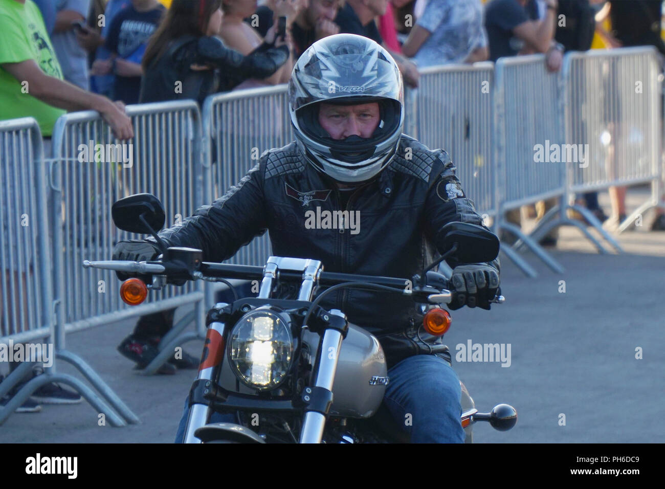Motorcyclist in a helmet riding a motorcycle Harley Davidson Stock