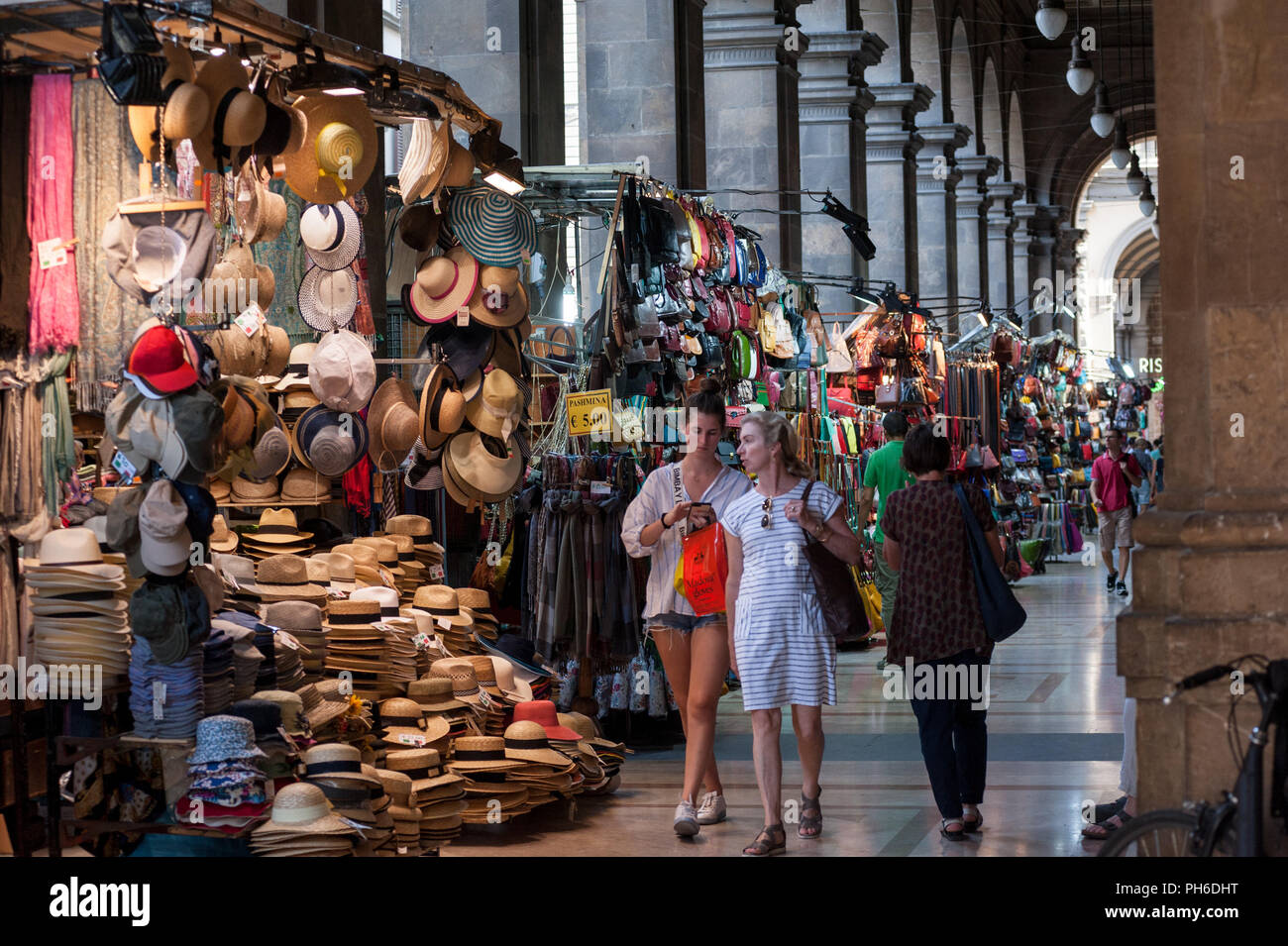 Florence, Italy 2018, July 14 People shopping at the market stall under the covered walk, in
