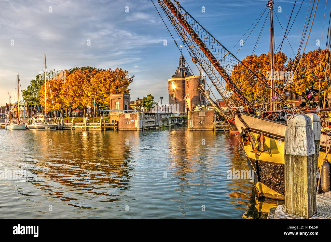 Enkhuizen, The Netherlands, October 26, 2015: historic saling yacht moored in the Buitenhaven (Outer Harbour) with Dromedaris Gate in the background Stock Photo