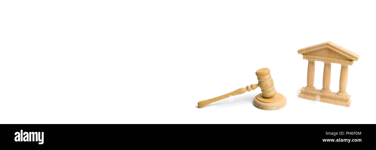 Wooden judge hammer and government building on a white background