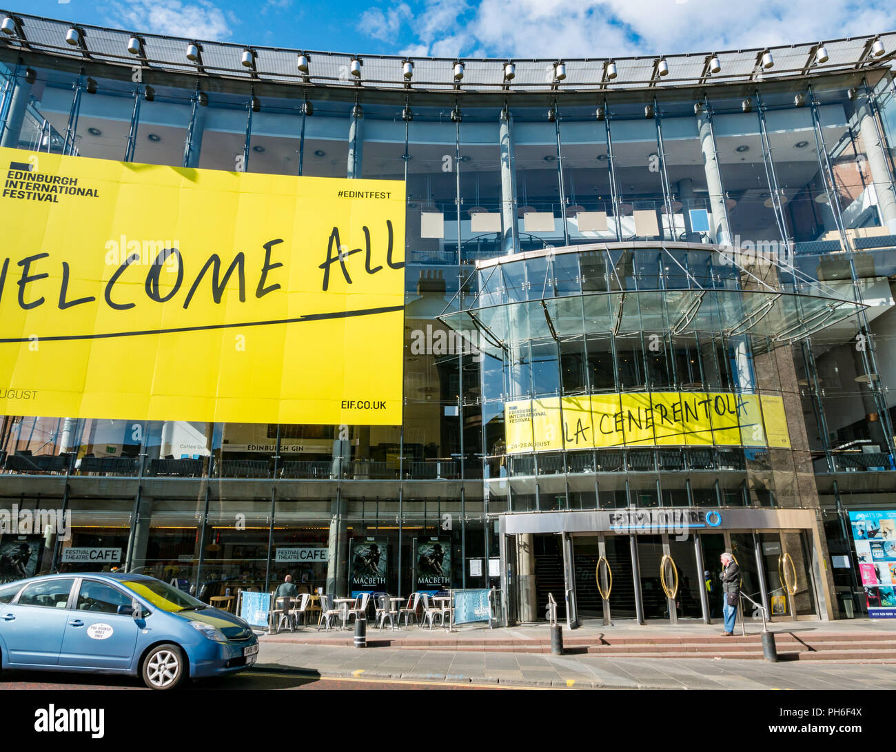 Front of Festival Theatre with yellow welcome all Edinburgh International Festival banner, Nicholson Street, Edinburgh, Scotland, UK with man waiting Stock Photo