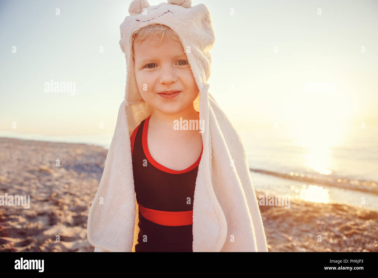 Portrait of cute adorable happy smiling toddler little girl with towel