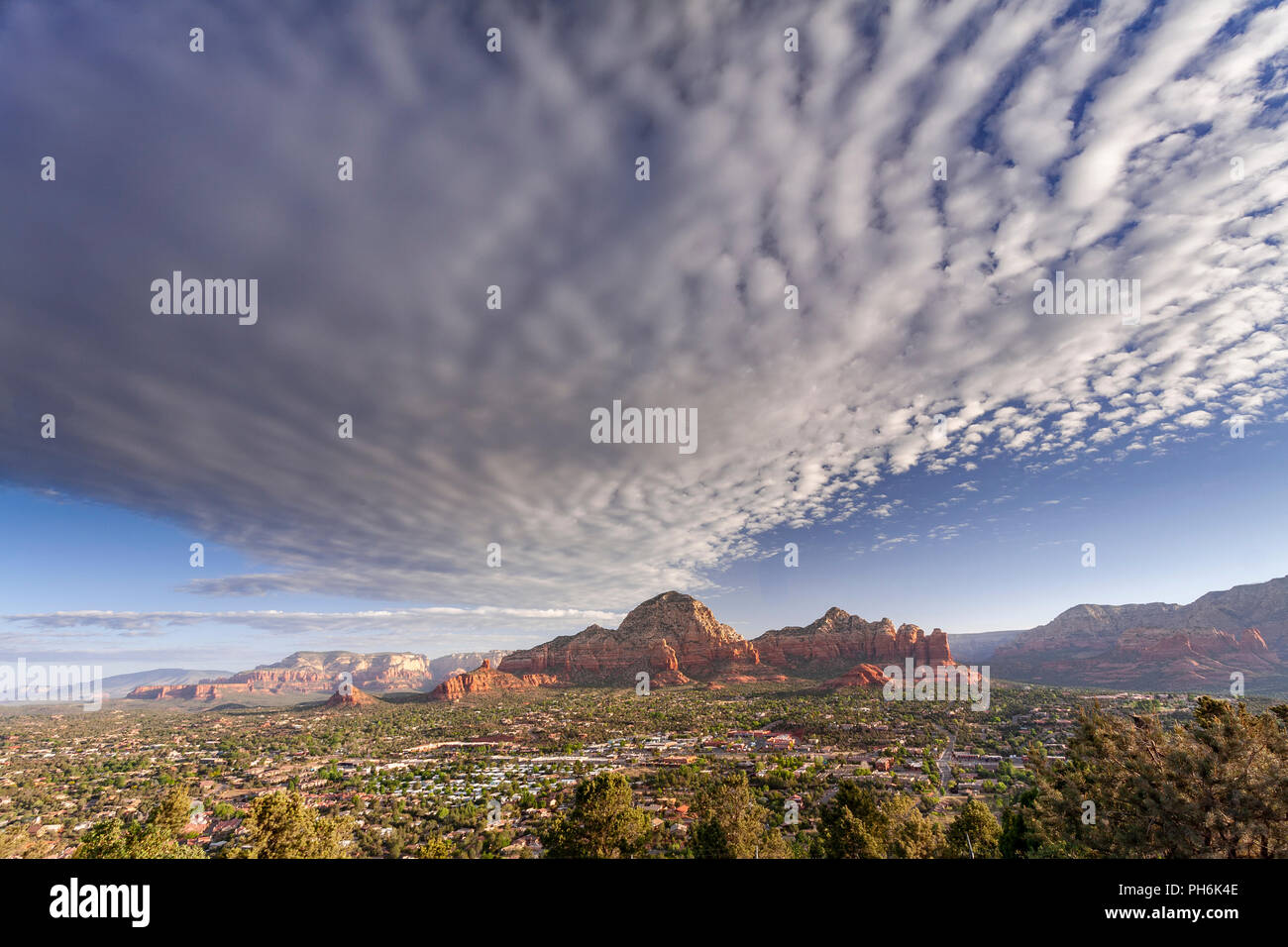 Sedona and surrounding sandstone buttes at sunrise with clouds, Arizona, USA Stock Photo