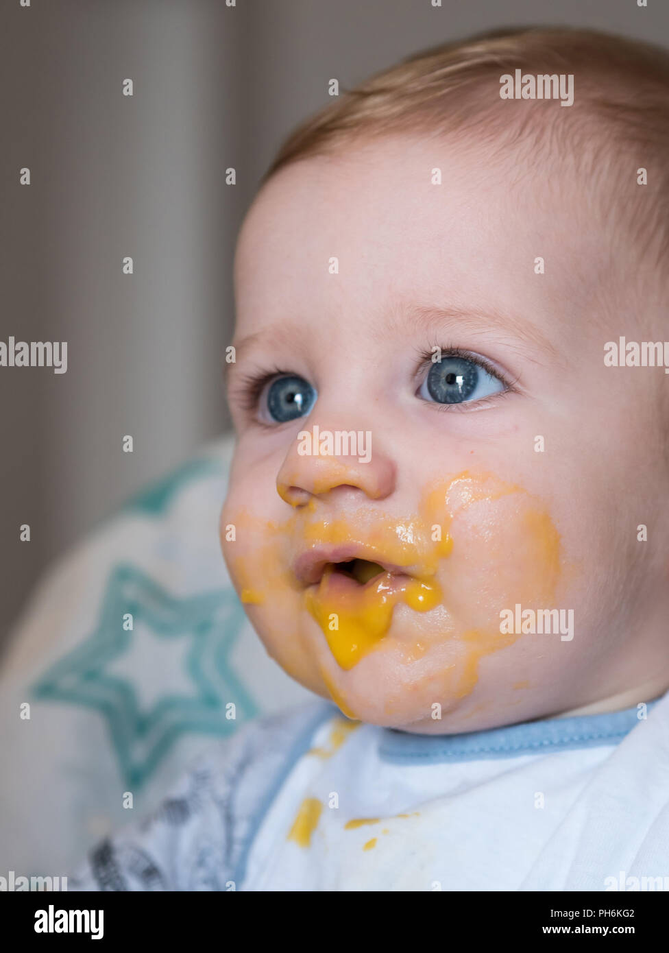 Adorable messy redhead baby boy with blue eyes close up Stock Photo
