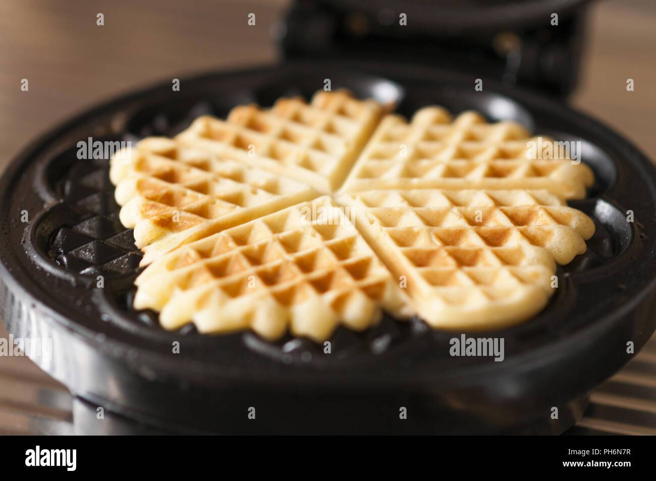 Waffles with a waffle iron Stock Photo Alamy