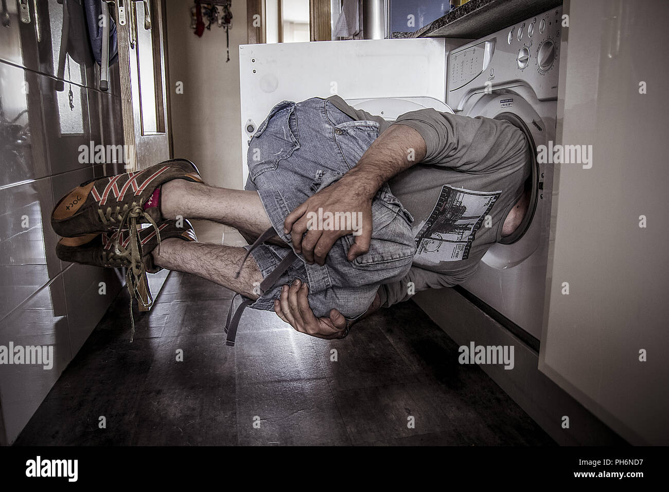 Man Flying With His Head Stuck In A Washing Machine Stock Photo Alamy
