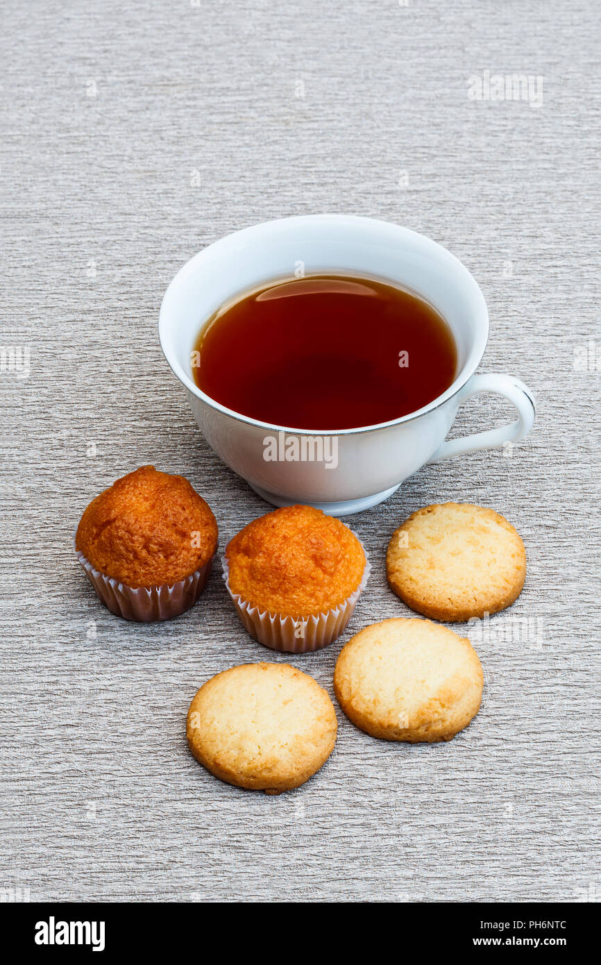 Cup cake, cookie and a cup of tea Stock Photo