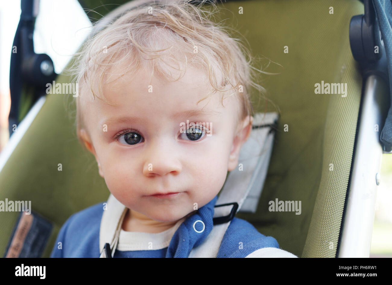 Close up Cute White Baby Boy on a Stroller Stock Photo