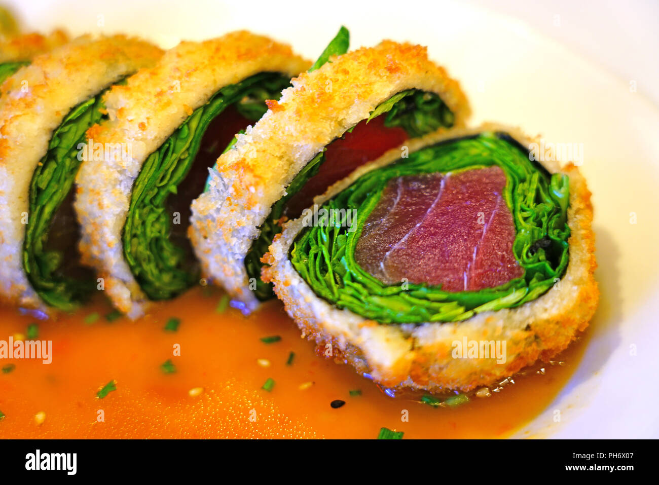 Deep fried panko crusted tuna and spinach sushi roll Stock Photo