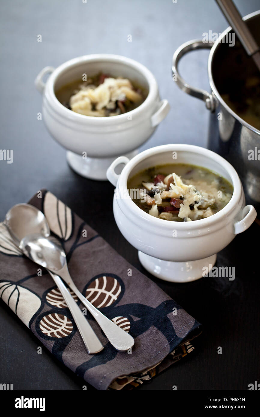 Potato, kale and sausage soup with pot Stock Photo