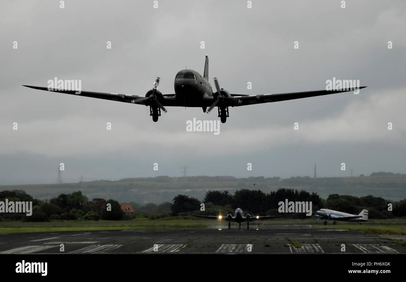AJAXNETPHOTO. 3RD JUNE, 2014. LEE-ON-SOLENT, ENGLAND. - TRIBUTE PLANES AIRBORNE - 8 DOUGLAS SKYTRAIN C-47A AND DAKOTA DC3 VARIANTS FLEW OUT FROM THE OLD RNAS HMS DAEDALUS AIRFIELD HEADED FOR FRANCE AND THE NORMANDY 1944 D-DAY LANDING BEACHES TODAY IN ONE OF THE LARGEST ANNIVERSARY AERIAL TRIBUTE EVENTS. FOUR OF THE EIGHT AIRCRAFT ASSEMBLED FROM AROUND THE WORLD PLANNED TO DROP UP TO 100 PARACHUTISTS NEAR THE TOWN OF CARENTAN.  PHOTO:TONY HOLLAND/AJAX.  REF DTH140406 9411 Stock Photo