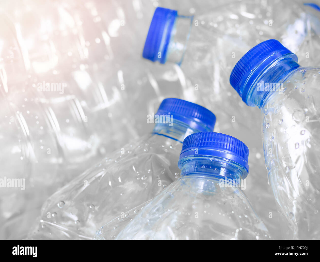 Close up empty crushed recycle clear plastic drink water bottles on