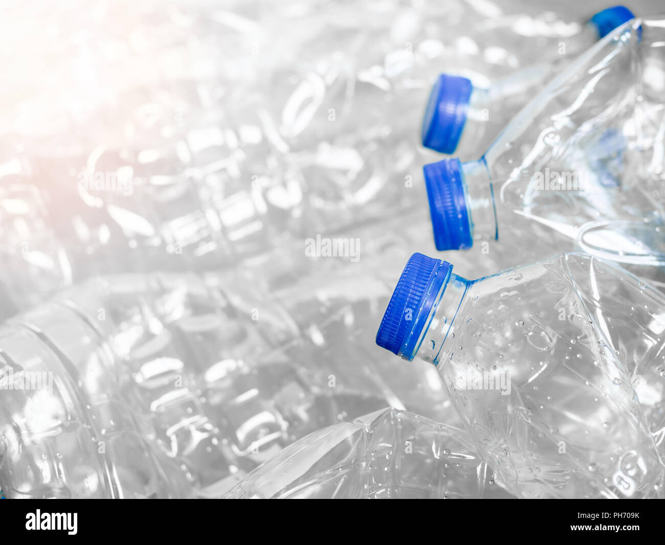 Close up empty crushed recycle clear plastic drink water bottles on